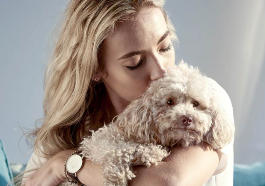 Woman carrying a puppy